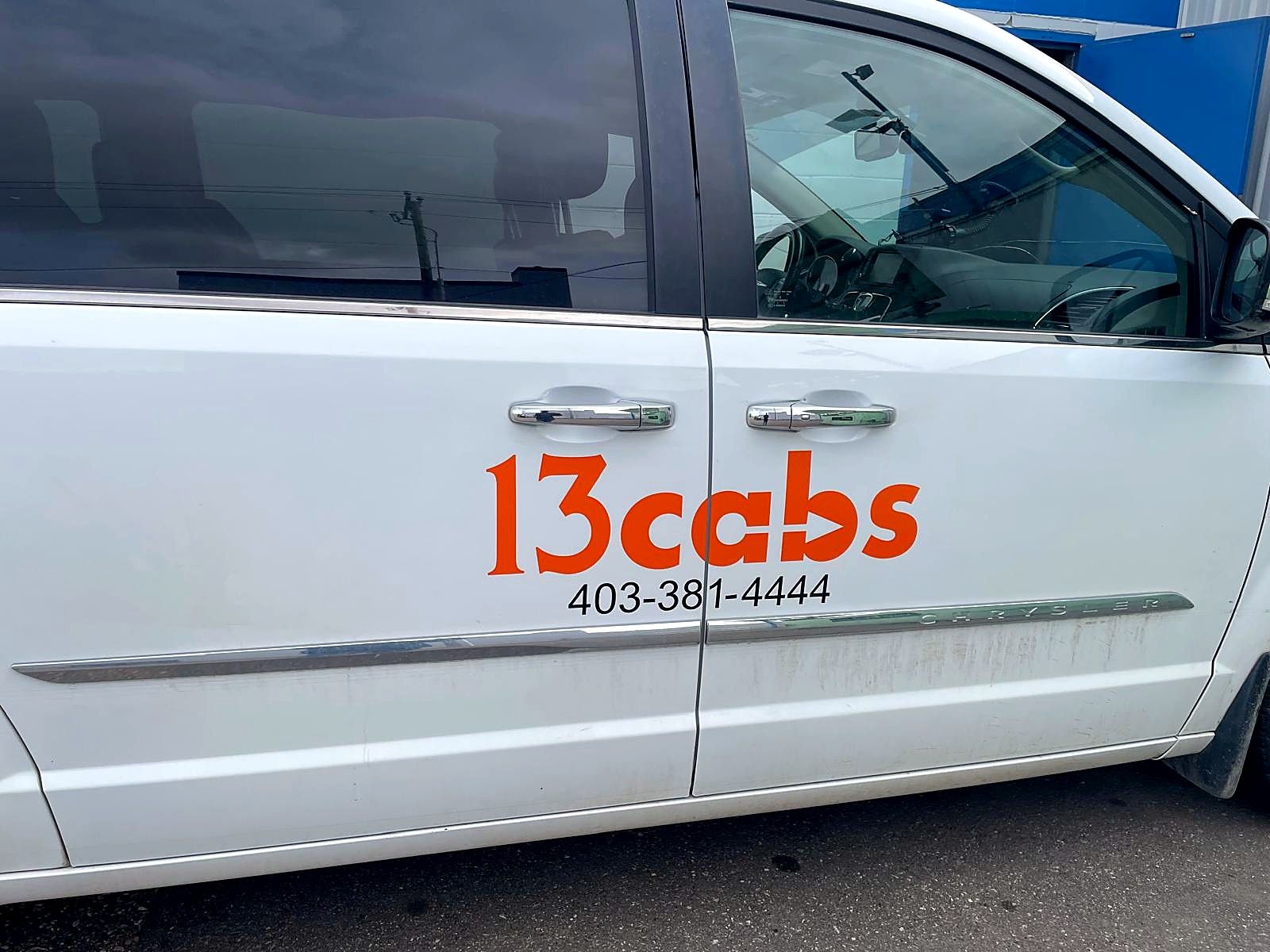 13cabs logo and phone number applied to the side of a white minivan